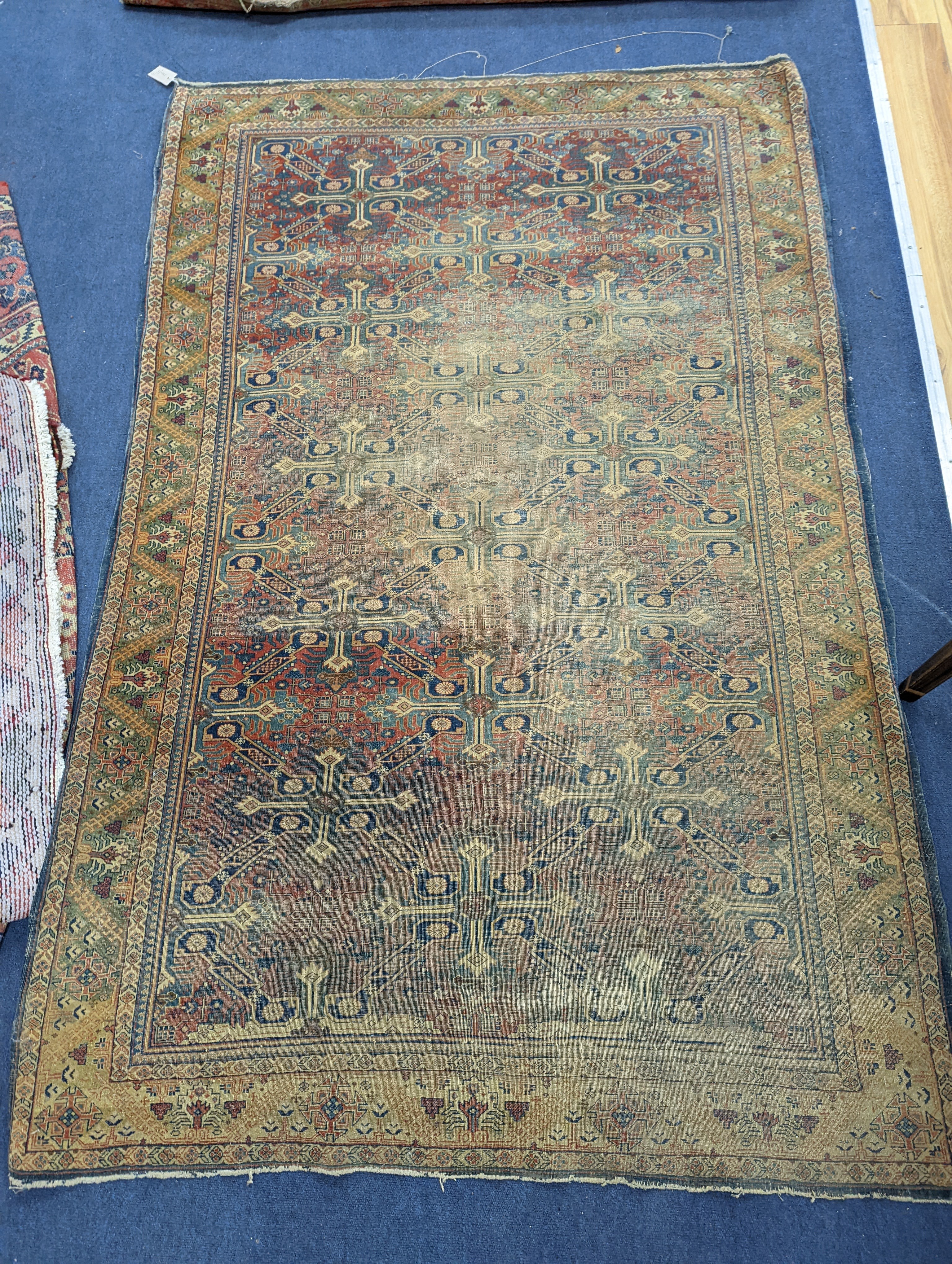 Three antique rugs, Caucasian and North West Persian, largest 230 x 154cm